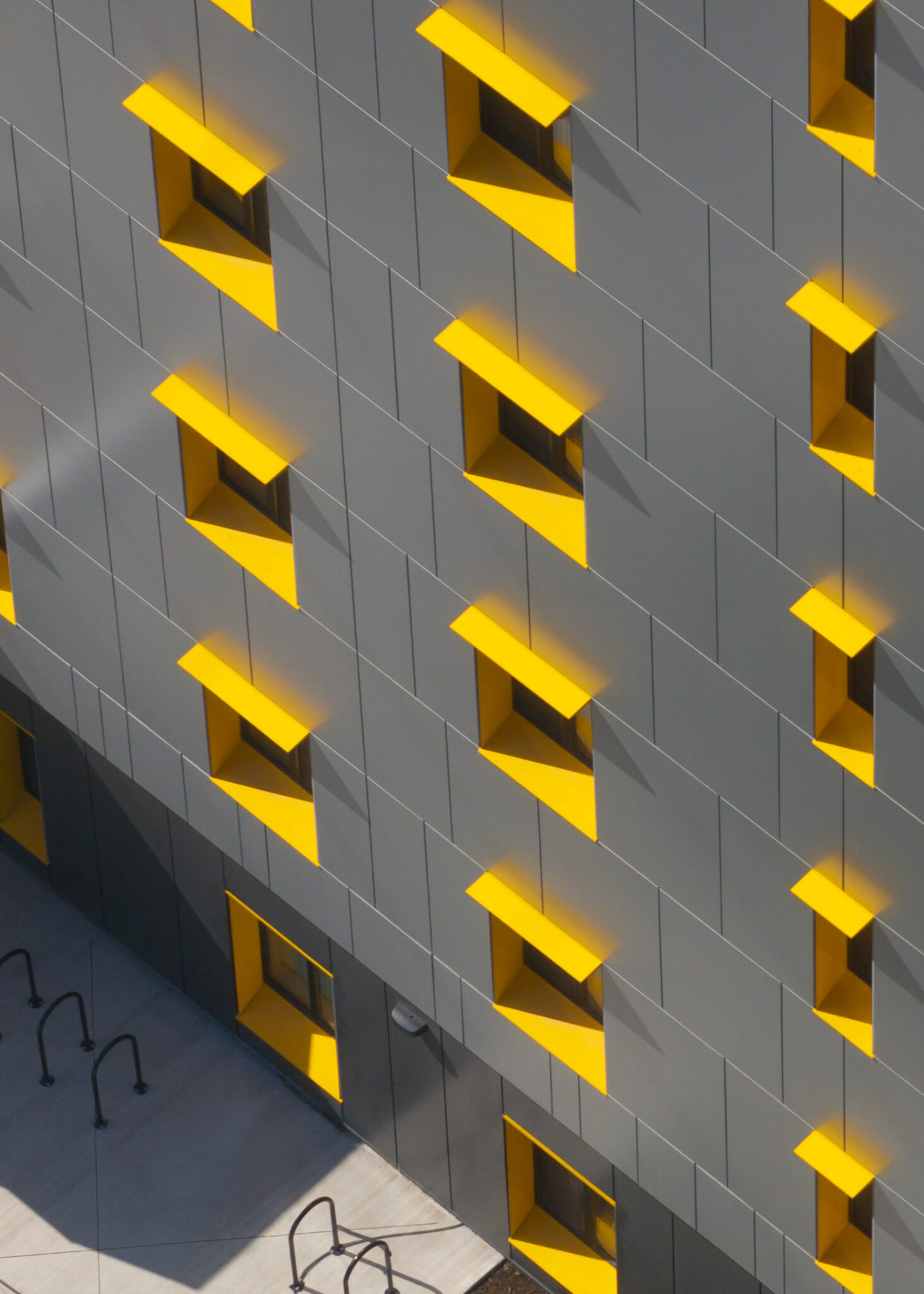 Completed mass timber housing exterior with yellow window frames